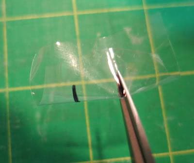 Snip the clear vinyl.