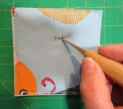 Puncture fabric to apply magnetic snap.