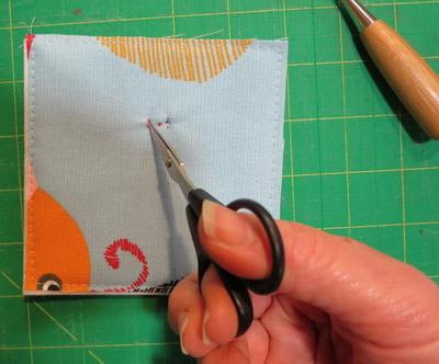 Puncture fabric to apply magnetic snap.