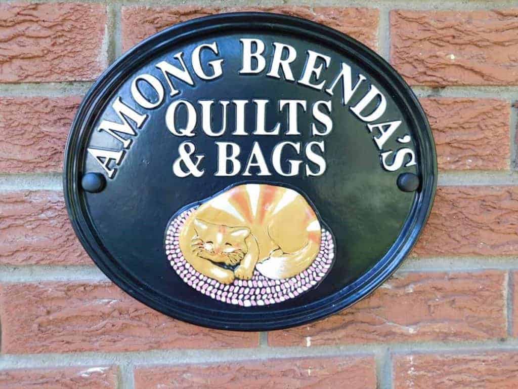 Among Brenda's Quilts & Bags Business Sign Crafted by Village Metalsmiths