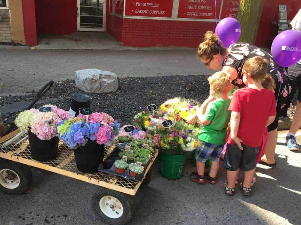 Family looking at flowers for sale.