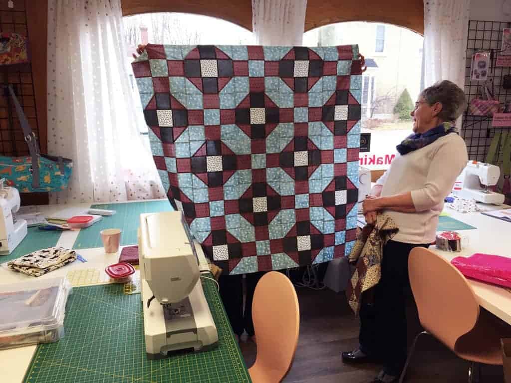 Bev LeDuc's lap sized quilt center, with Mary Faber looking on. 
