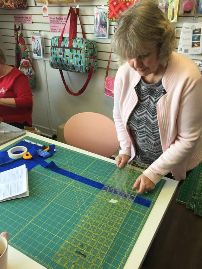 Janet makes binding for a baby quilt.