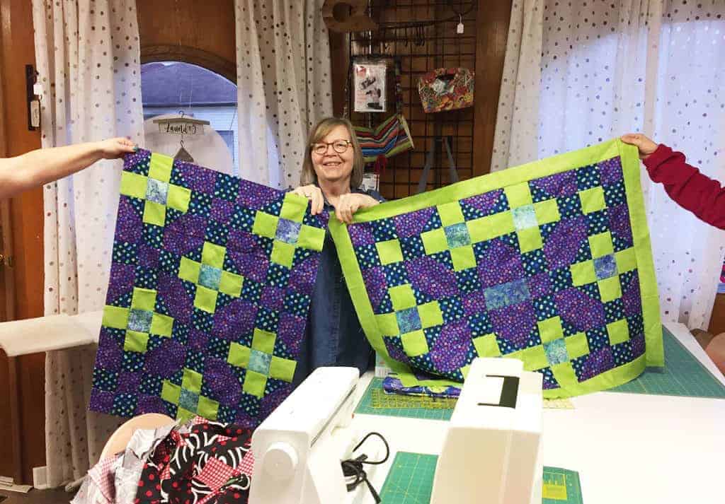 Lyn Galajda, instead of making a lap quilt, re-jigged her blocks into two baby quilts.