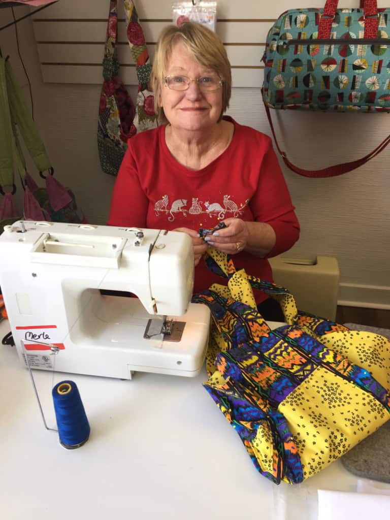 Merle working on making an apron.