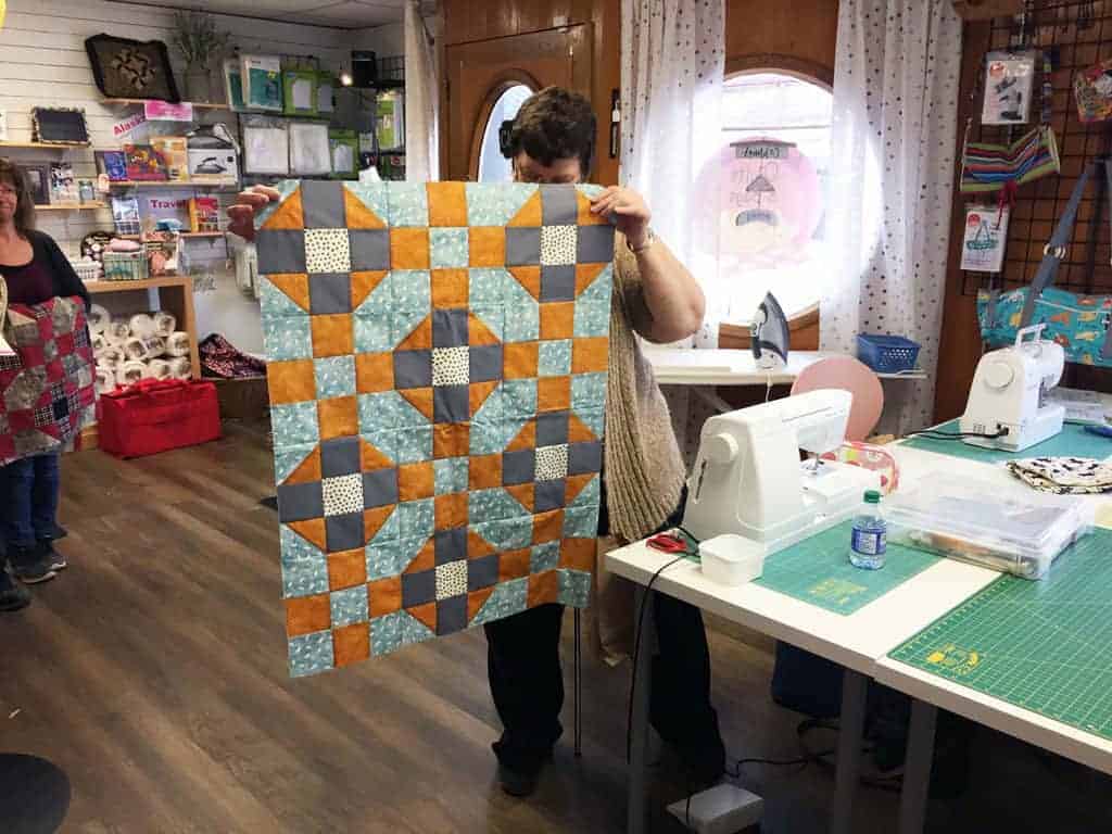 Nori Quinn's baby quilt gets a subtle look with the addition of grey.