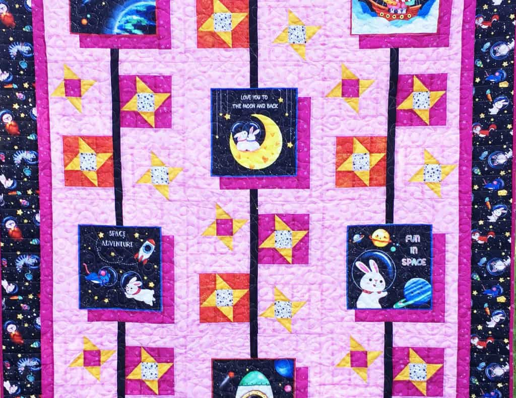 Quilt with pinwheels and printed squares