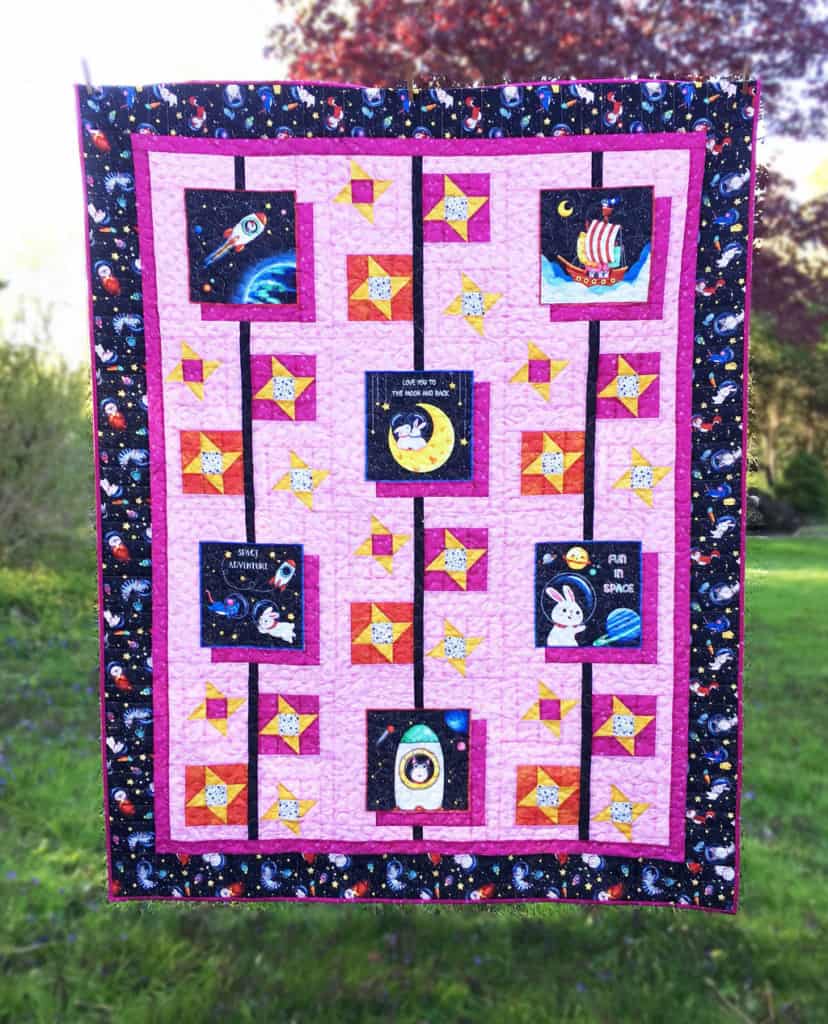 Panel Play: Seeing Stars quilt hanging outdoors