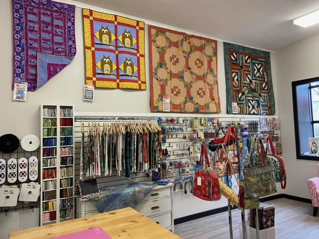 Samples of wall hangings and bags on display with their patterns