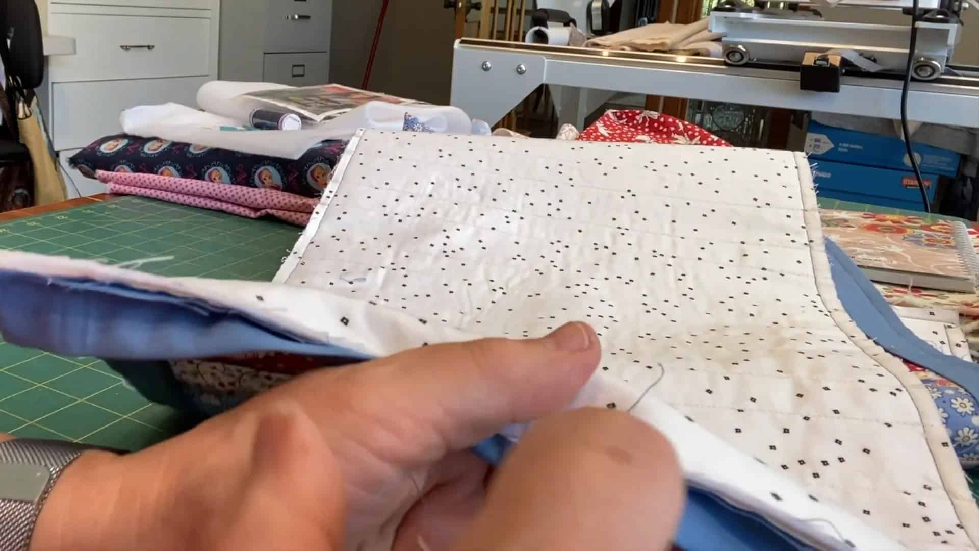 Quilt binding tutorial: Hand stitching the binding to the back of the quilt