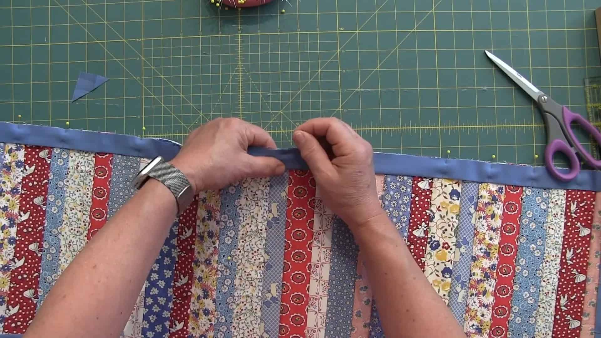 Finalizing the binding on the quilt