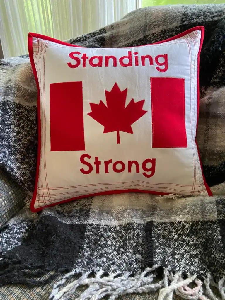 A Standing Strong Pillow, featuring a Canadian Flag.