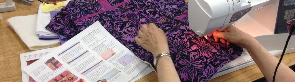 Sewing a bag while consulting a pattern. 
