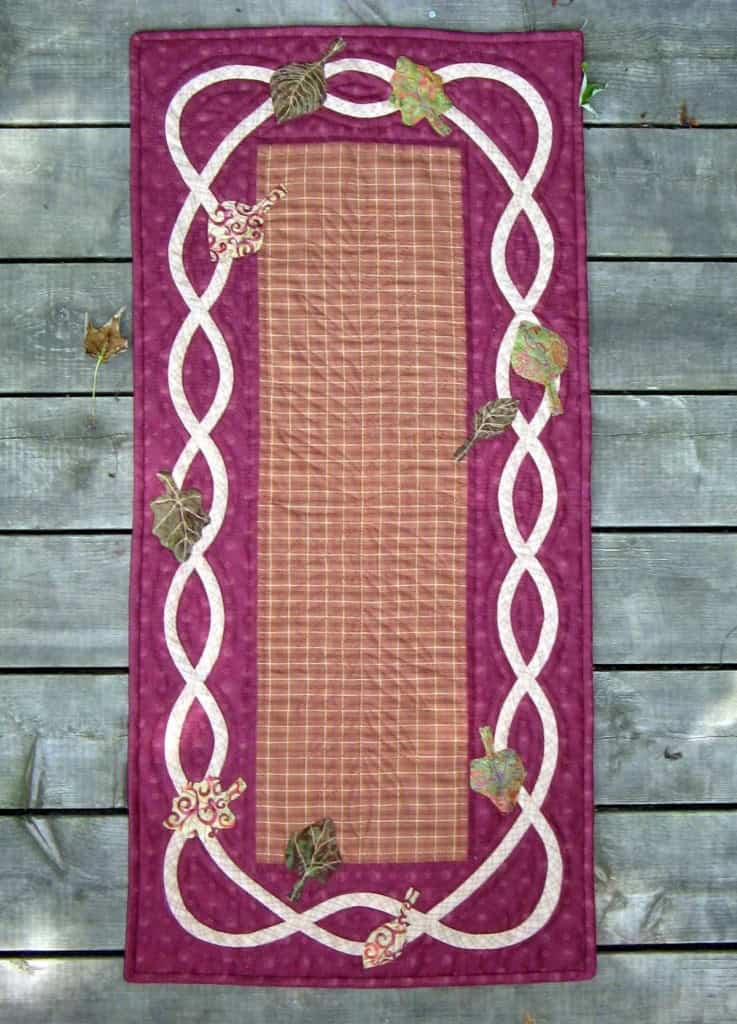 Celtic Harvest table runner made with hand applique.