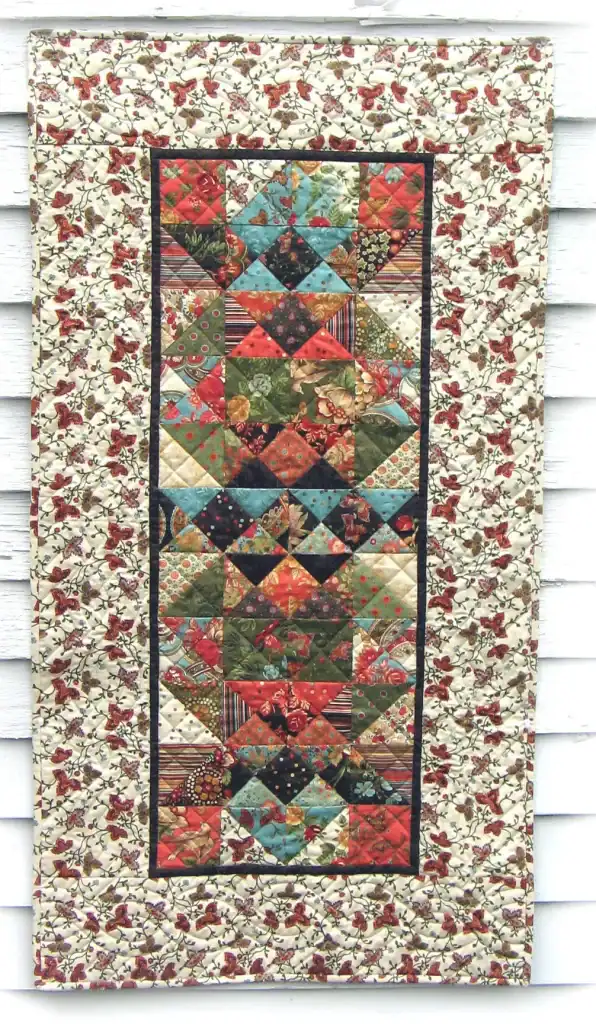 Fiesta Tortuga, a
Charm Square Table Runner Pattern