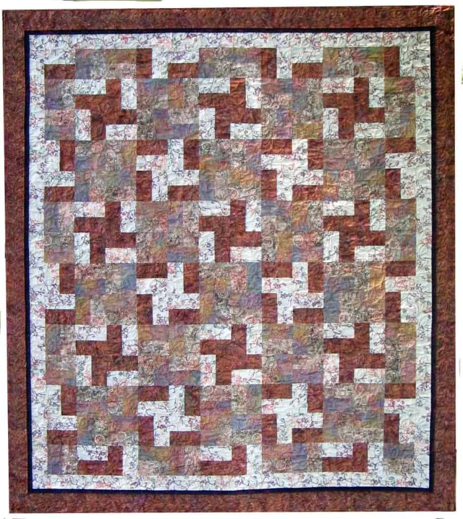 Colorful quilt made from geometric East Meets West pattern.