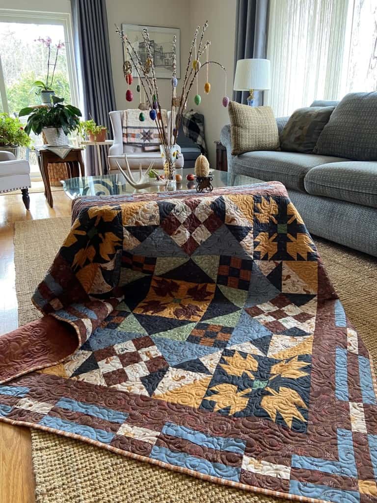 Finished Sugarbush Crossings quilt displayed in living room.